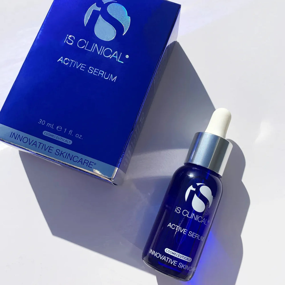 iS Clinical Active Serum blue glass dropper bottle next to matching blue box on white background