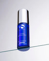 Blue cylindrical bottle of iS Clinical Copper Firming Mist with silver cap on glass surface