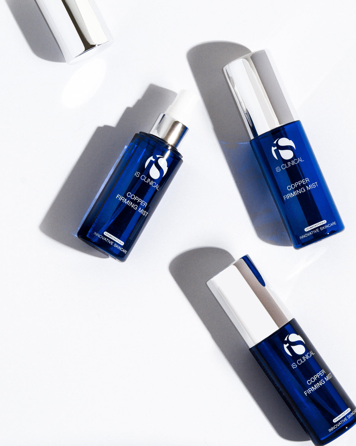 The iS Clinical Copper Firming Mist applied as a fine, even spray over the face