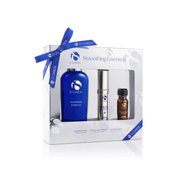iS Clinical Limited Edition Smoothing Essentials set with Cleansing Complex, Youth Eye Complex, and Pro-Heal Serum Advance+ in white box with blue ribbon