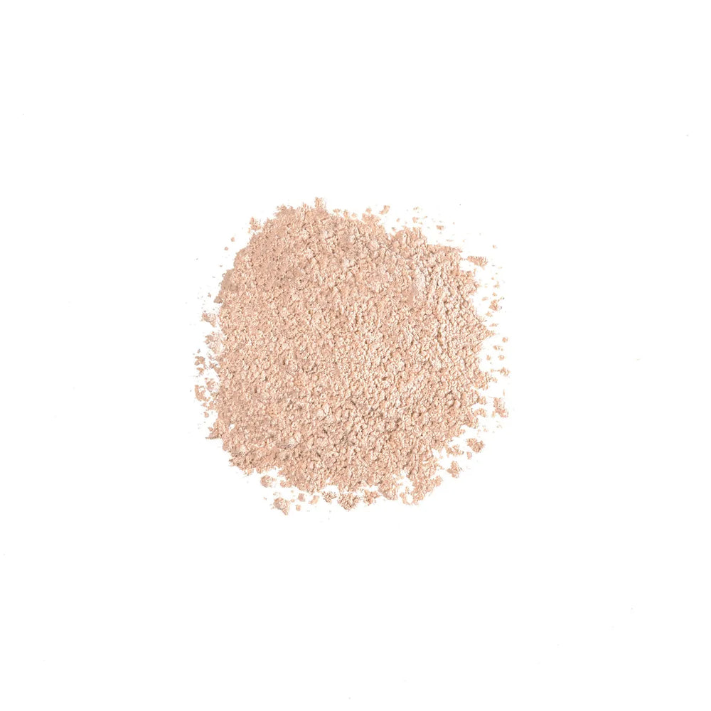 Loose beige powder of iS Clinical PerfecTint Powder SPF 40 on a white background