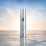 Silver bottle of iS Clinical Reparative Moisture Emulsion 50g standing on water at sunrise