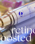 Close-up of iS Clinical Retinol+ Emulsion 0.3 pump bottle with reflective surface and blurred background