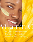 Close-up of smiling woman applying pale yellow emulsion to cheek with text about Vitamin C benefits