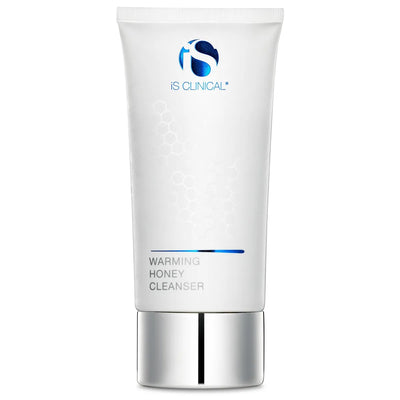 White tube of iS Clinical Warming Honey Cleanser with silver cap and blue logo on white background